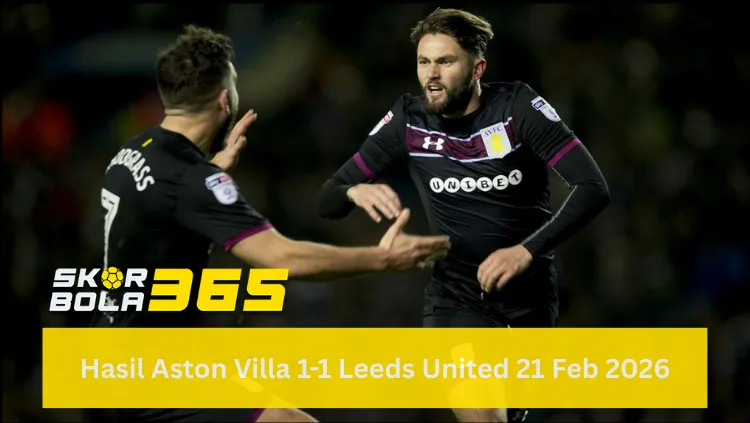 Dua pemain Aston Villa mengenakan jersey hitam dengan detail garis marun (sponsor Unibet) sedang berinteraksi di lapangan; pemain di kanan (Henri Lansbury) tampak berteriak memberikan instruksi atau merayakan momen dengan tangan terbuka, sementara pemain di kiri membelakangi kamera; terdapat logo SKOR BOLA 365 di pojok kiri bawah dan teks "Hasil Aston Villa 1-1 Leeds United 21 Feb 2026" pada bilah kuning di bagian bawah.